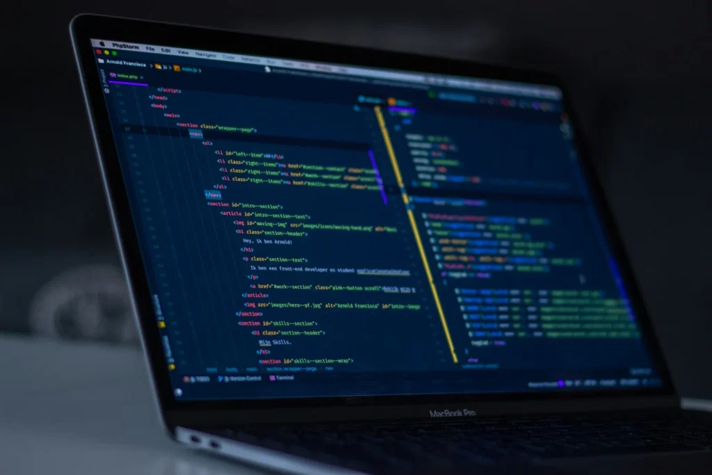 Laptop screen showing website code in a code editor