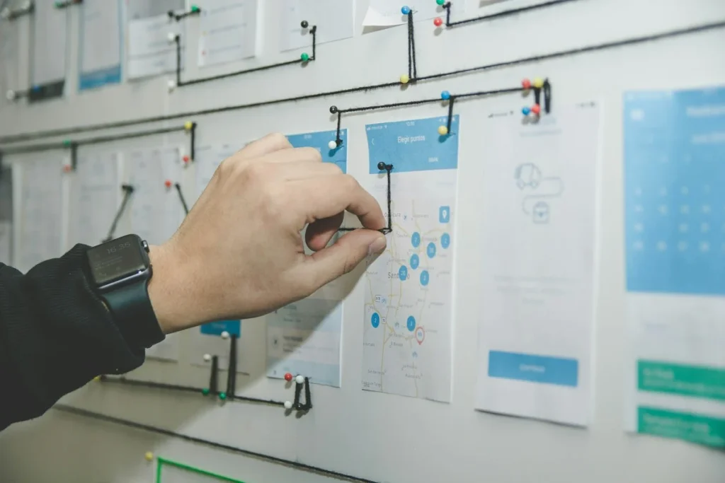Hand pinning website page layouts on a planning wall