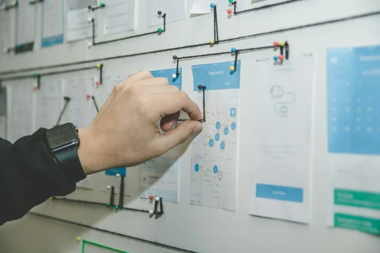 Hand pinning website page layouts on a planning wall
